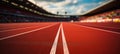 Close-up of a running track in a stadium with white striped markings.