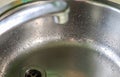 Running water out of a water tap in a metallic kitchen sink Royalty Free Stock Photo