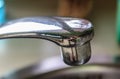 Running water out of a water tap in a metallic kitchen sink Royalty Free Stock Photo
