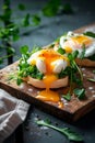 Close-up the runny yolk of a poached egg, the Eggs Benedict recipe, accompanied by a toast and fresh greens for a nutritious twist