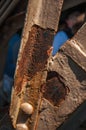 Close-up of rust on bars of the iron structure of the Eiffel Tower in Paris.