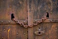 Close-up of a rusted, chained door lock evoking concepts of secrecy and time passage Royalty Free Stock Photo