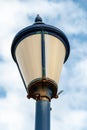 Close up of a rusted street lamp with chipped blue paint work