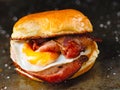 Rustic bacon egg breakfast sandwich bun Royalty Free Stock Photo