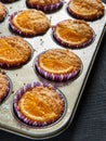 Home made orange muffins in a rustic baking tray