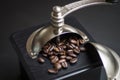 Close up of a rustic black wooden coffee grinder with roasted coffee beans with selective focus Royalty Free Stock Photo