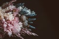 Close up of a rustic bridal bouquet on a dark background