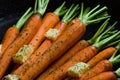 Close up of rustic carrotts in a pan with butter on wood Royalty Free Stock Photo