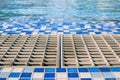 Close up rustic grate of water drainage system on the edge of swimming pool. Royalty Free Stock Photo