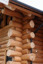 Close-up of a rustic log cabin corner showcasing interlocking wooden logs and craftsmanship. Royalty Free Stock Photo
