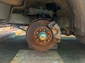 rusty broken car with missing wheel