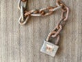 Close up of rusty chain and locker put on the ground, on top view Royalty Free Stock Photo