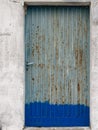 Rusty grey and blue metal door with peeling paint Royalty Free Stock Photo
