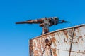 Close-up of rusty harpoon gun in bows