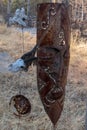 Close up of a rusty metal african mask in mobile formate