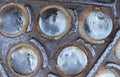 Close-up of a rusty metal plate with rivets and holes Royalty Free Stock Photo