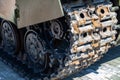 Close-up on a rusty old caterpillar of a green tank worn on wheels standing on the road. Military equipment for the murder and the Royalty Free Stock Photo
