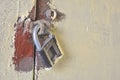 Close up of rusty old key lock on the painted white wall Royalty Free Stock Photo