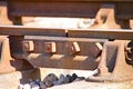 Close up of rusty railway track showing the nuts and bolts of the fishplate which joins sections of track