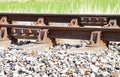 Close up of rusty railway track showing the nuts and bolts of the fishplate which joins sections of track