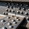 Close up of a rusty steel structure with numerous large rounded rivets Royalty Free Stock Photo