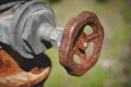 Close-up of a rusty tap valve on an old water pump. Royalty Free Stock Photo