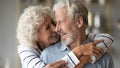 Closeup image elderly wife hug from behind beloved husband