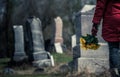 Close-up of a Sad in front of a Gravestone. Royalty Free Stock Photo