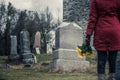 Close-up of a Sad in front of a Gravestone. Royalty Free Stock Photo