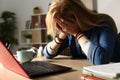 Sad student receiving bad news on laptop at night Royalty Free Stock Photo