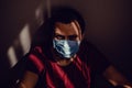 Close up sad thoughtful adult man portrait in medical mask sit leaning on wall with stare eyes. Stay isolation at home. Quarantine Royalty Free Stock Photo