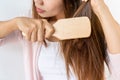 Close up of sad young Asian girl with her damaged and tangled hair.  on white background, copy space Royalty Free Stock Photo