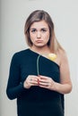 Close up Sad Young Woman Holding a Dead Rose Flower While Looking at the Camera Royalty Free Stock Photo