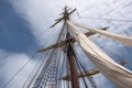 close-up of sailboat mast and rigging, with the sails billowing in the wind Royalty Free Stock Photo