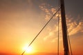 close-up of sailboat mast with setting sun in the background