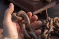 Close-up of a sailor's hand. A sailor holds a metal mooring chain in his hand. Securing the ship with a large chain. Royalty Free Stock Photo