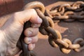 Close-up of a sailor's hand. A sailor holds a metal mooring chain in his hand. Royalty Free Stock Photo