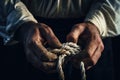 close-up of a sailors hands tying a knot on a rope