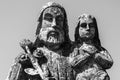 Close up saint Joseph with little Jesus Christ. Very ancient stone statue. Black and white image Royalty Free Stock Photo