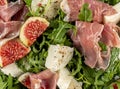 Close up Salad with arugula , figs, prosciutto and mozzarella