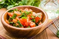 Close-up of salad made of tomatoes and fresh herbs, vegetable oil and fork Royalty Free Stock Photo