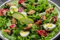 Close up salad with mussels, quail, egg, conjugate, lime, spinach, lettuce, cherry tomatoes and microgreen. Dietary salad. top