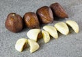 Close up salak fruit sliced with black background on grey stone Royalty Free Stock Photo