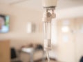 Close-up of Saline solution drip for patient and infusion pump on blurred luxury VIP room background in hospital Royalty Free Stock Photo