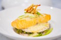 Close-up of salmon fillet with rice cakes, green beans, lemon butter garlic sauce. Seafood dish on white plate. Healthy lunch. Royalty Free Stock Photo