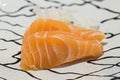 Close up salmon slice. salmon topped by fresh salmon served with wasabi and soy sauce, donburi rice.