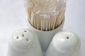 Salt and pepper shakers and toothpicks on restaurant table Royalty Free Stock Photo