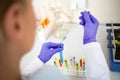 Close up of sampling colorful liquids with glass pipette