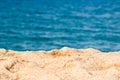 Close up on the sand of a beach, blue sea water Royalty Free Stock Photo