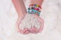 Close-up of sand heart in woman's hands